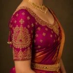 Temple motif bridal blouse sleeve featuring handcrafted Aari embroidery