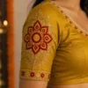 Kerala Kolam sleeve embroidery design with floral Aari work, zari and stone embellishments
