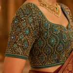 Peacock Bell Aari Blouse sleeve design featuring heavy stone work and bridal Maggam embroidery