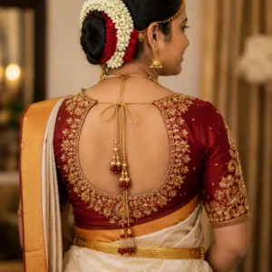 Kerala bridal blouse back neck design with intricate Aari embroidery and handcrafted Maggam work