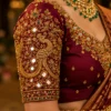 Close-up sleeve view of Bridal Peacock Aari Embroidery with heavy mirror work, zari, kundan stones and intricate peacock design.