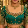Emerald green Aari bridal blouse front view with gold sunburst embroidery and mirror work