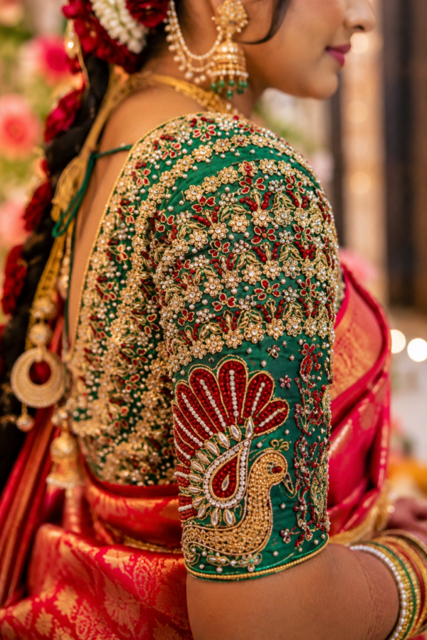 Close-up of handcrafted peacock sleeve Aari embroidery with kundan stones, pearls and Maggam work