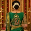 Back view of Emerald Green Peacock Aari Bridal Blouse with royal peacock motif, temple arch embroidery, antique zari, and handcrafted Aari work.