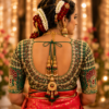 Back neck bridal blouse featuring deep U neck with heavy Aari embroidery, kundan work and Maggam embroidery