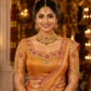 Golden Temple Heritage Bridal Aari Blouse Front View with premium Maggam Work, kundan stones, antique coin embroidery and floral neckline.