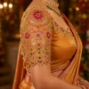 Luxury Bridal Aari Blouse Sleeve Design with floral Maggam Work, kundan stones, ruby and emerald embellishments, and scalloped border.
