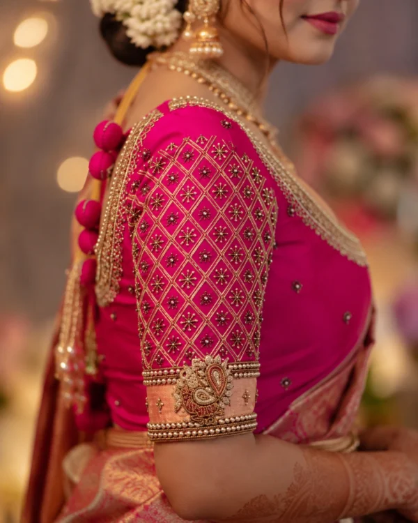 Pink bridal blouse sleeve with diamond lattice Aari embroidery and gold Maggam work