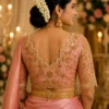Pink gold bridal blouse back view with floral Maggam work and embellished scalloped neckline