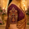 Close-up sleeve view of Royal Maroon Temple Peacock Bridal Aari Work Blouse showcasing intricate peacock motif, temple-inspired embroidery, zardosi, pearls and kundan work.