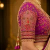 Detailed sleeve embroidery of the Royal Radha Krishna Bridal Aari Blouse with floral vines, zari work, beads, and pearl hanging border.