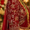 Close-up of Royal Ruby Velvet Bridal Blouse sleeve showcasing intricate floral vine Aari embroidery, zari work, beadwork and pearl hanging border.